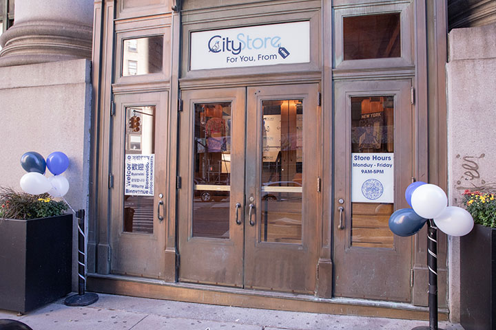 Centre St entrance to the CityStore with balloons and decals in the windows.