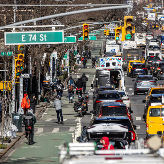 Overhead traffic lights at a busy street on East 74 Street.
