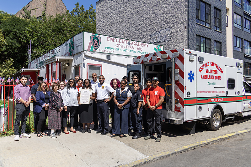 DCAS and BSVAC representatives pose in front of 727 Greene Avenue.