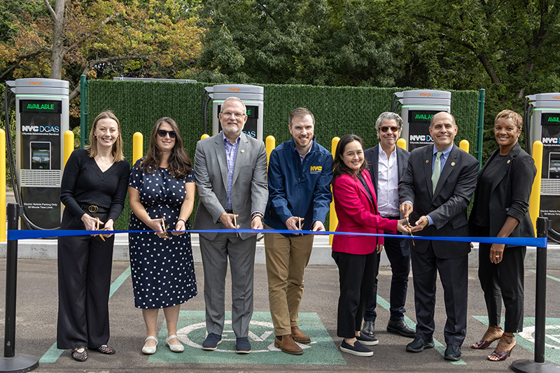 Empire Clean Cities Executive Director Joy Gardner, Queens Borough President Donovan Richards&rsquo; Transportation and Parks Liaison Laura Shepard, NYC Parks First Deputy Commissioner Mark Focht, TLC Deputy Commissioner for Policy and External Affairs James DiGiovanni, DCAS Commissioner Yume Kitasei, DCAS Deputy Commissioner for Fleet Management Keith Kerman, and DCAS Executive Deputy Commissioner Shameka Overton cut the ribbon on Forest Park&rsquo;s new EV chargers.