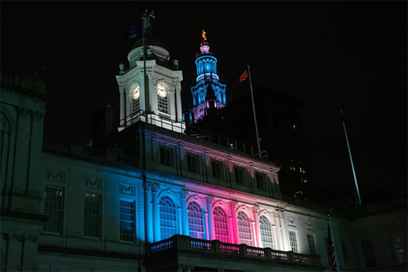 The new lighting system at City Hall will allow for custom lighting with better, more vibrant lighting that also reduces energy use. Pictured here, City Hall and the David N. Dinkins Municipal Building were lit for Trans Day of Visibility on March 31, 2022.