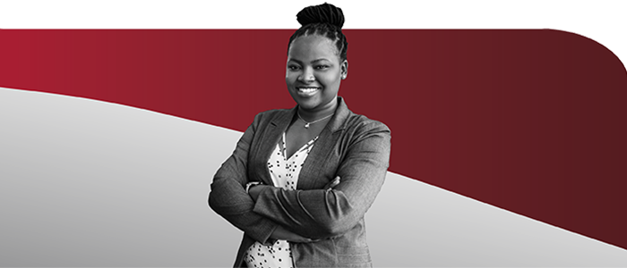 Young woman with braided hairstyle smiling with arms crossed