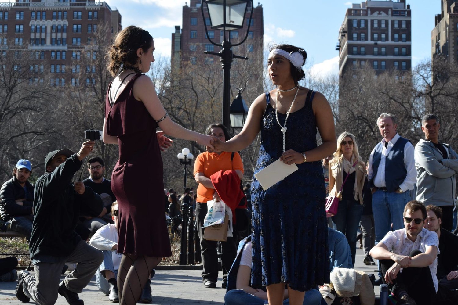 Photograph of Cailtyn McCain and another actor performing in front of a live audience.