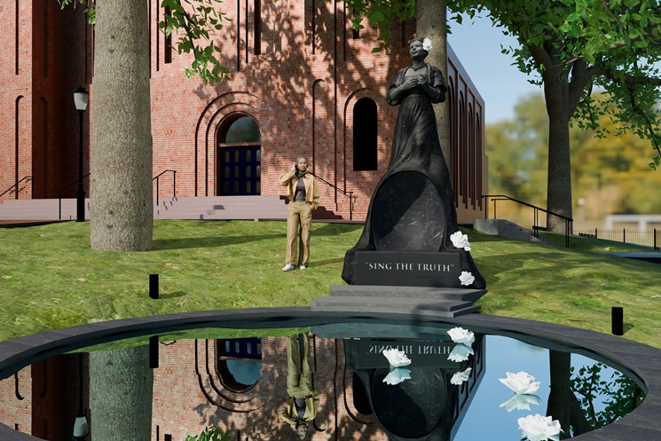 Rendering of a proposed monument to Billie Holiday featuring a tall dark sculpture of the singer standing with her hands crossed over her chest and a flower in her hair. The monument includes the inscription ‘Sing the Truth’ and stands beside a circular reflecting pool with floating white flowers, set on a grassy lawn in front of a brick cathedral-like building.