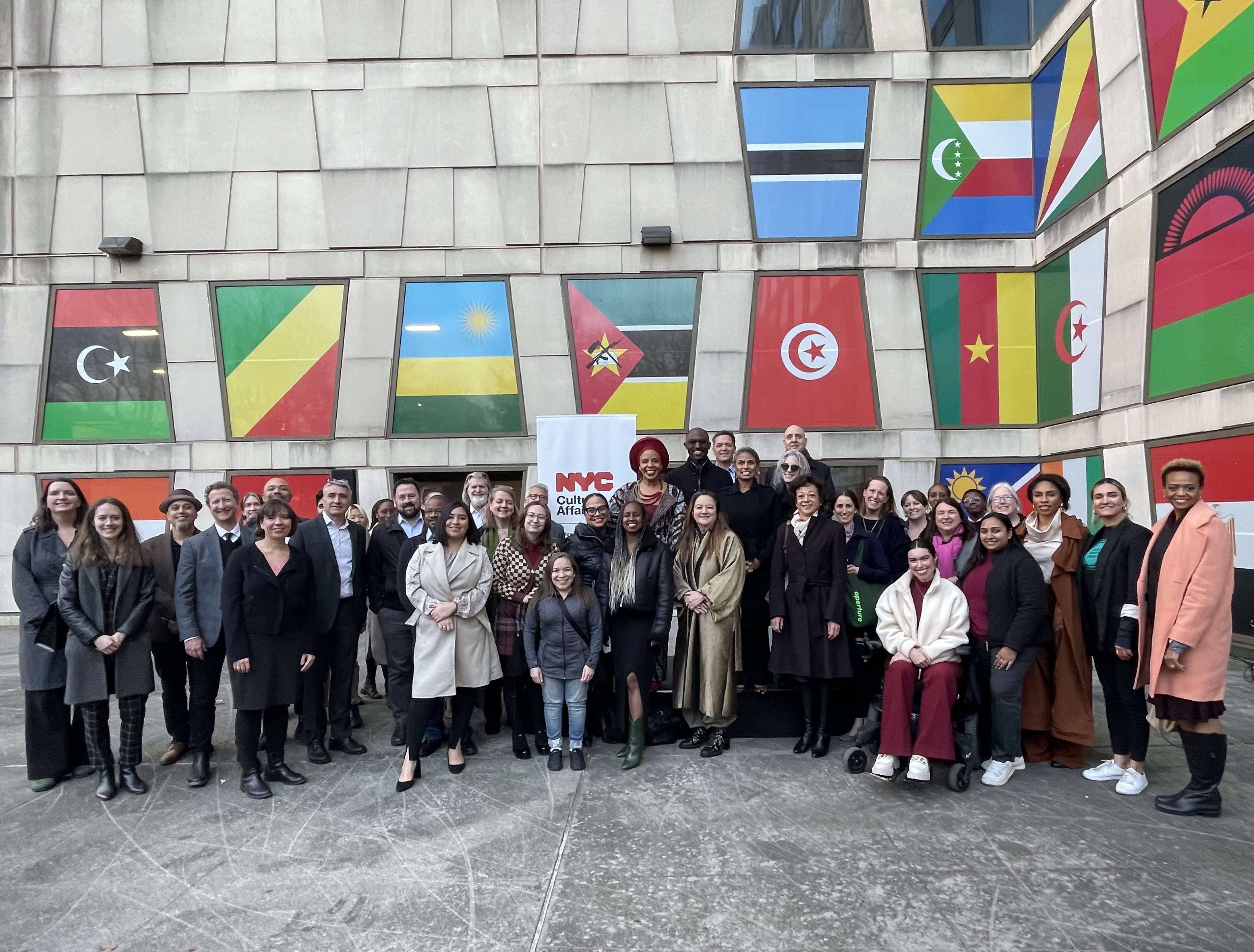 A group photo of people celebrating in front of The Africa Cent