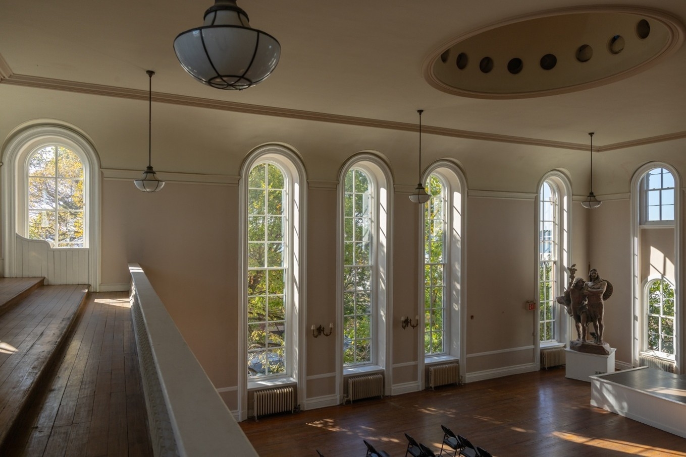 A photo of the interior of the institute with renovated windows and a statue.