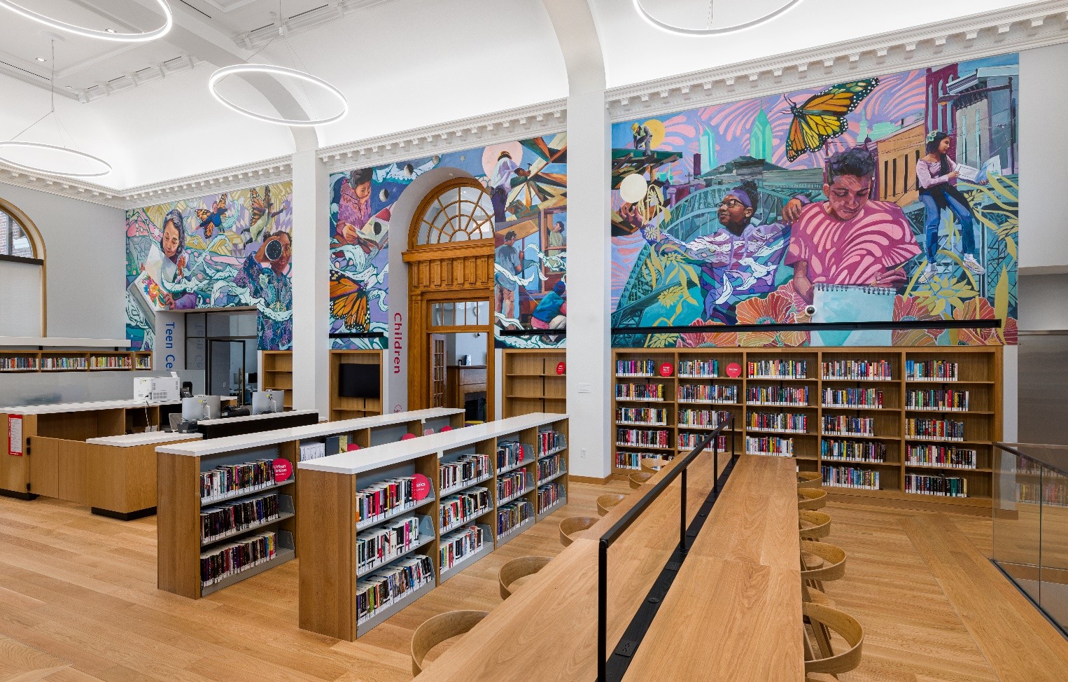Greta McLain's vibrant mural of children reading with butterflies. 