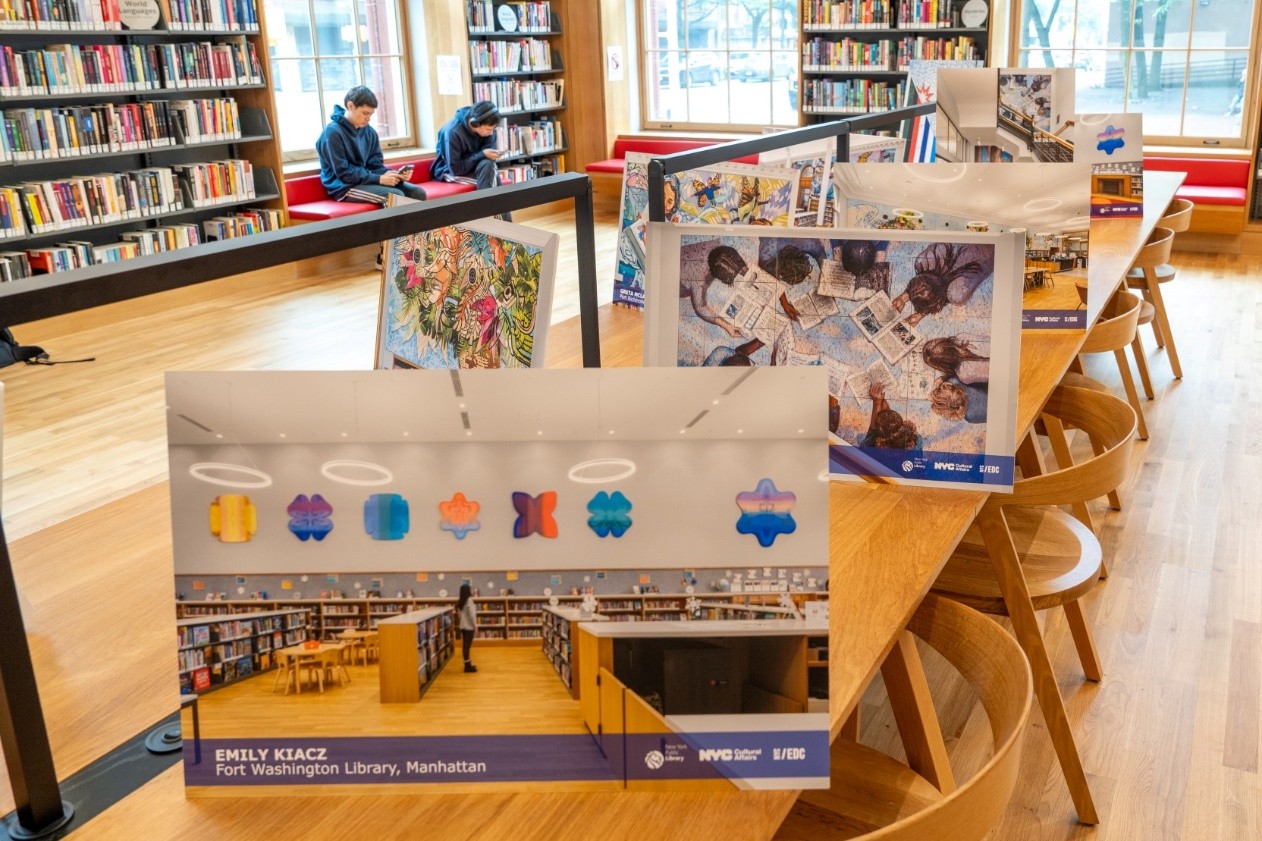 Photos of the new artwork are displayed on posters at Hunts Point library. 