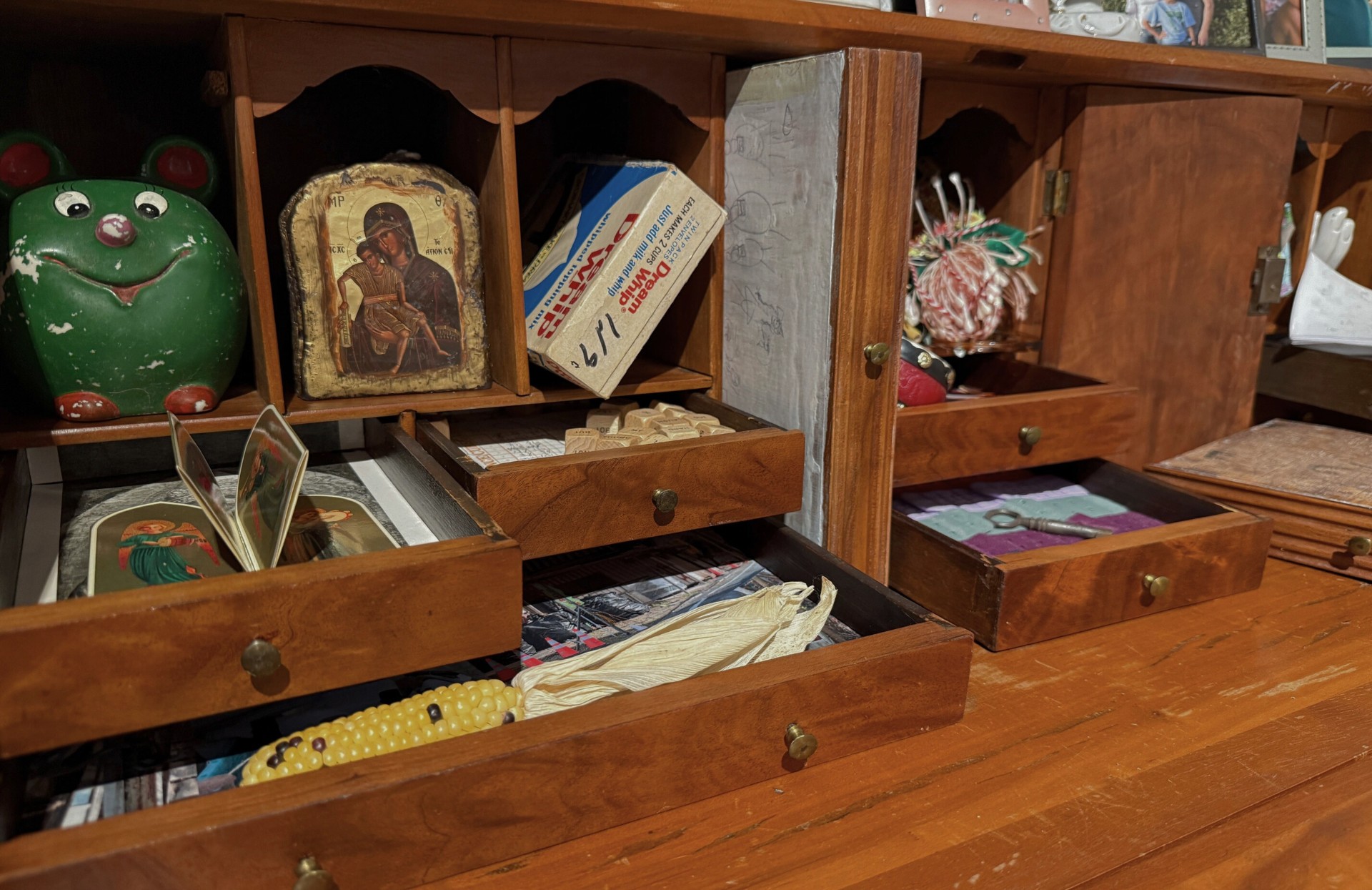 Figurines, cards, photos, and blocks fill a cabinet in the MFTA gallery.