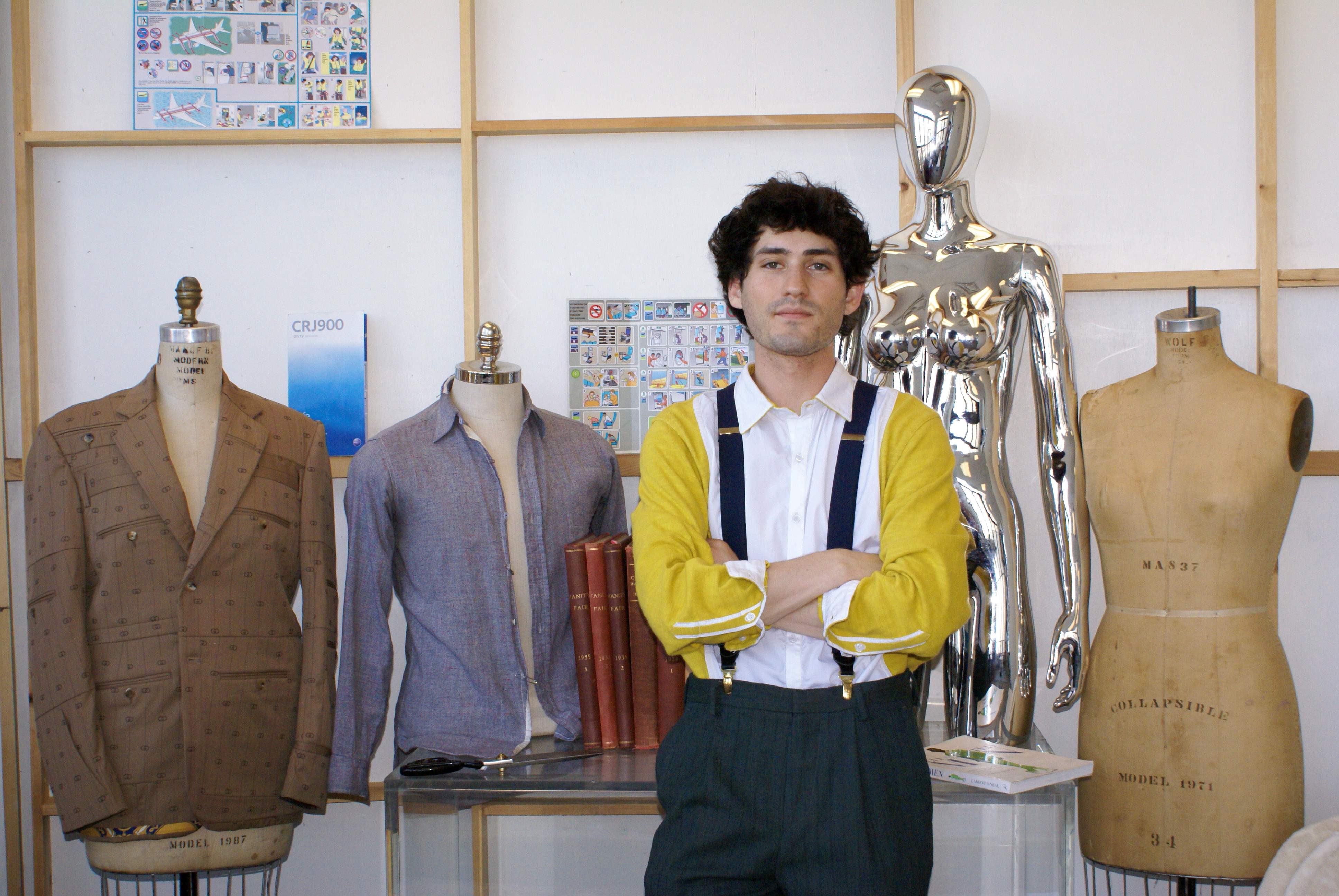 Victor Pearlman smiles in the MFTA designer studio surrounded by mannequins.  