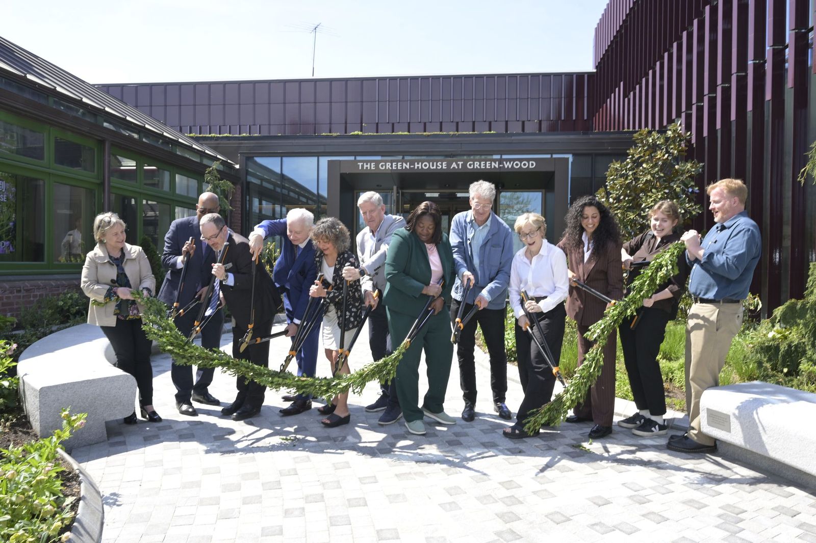 Cultural leaders and partners cut the garland on the new visitor center. 