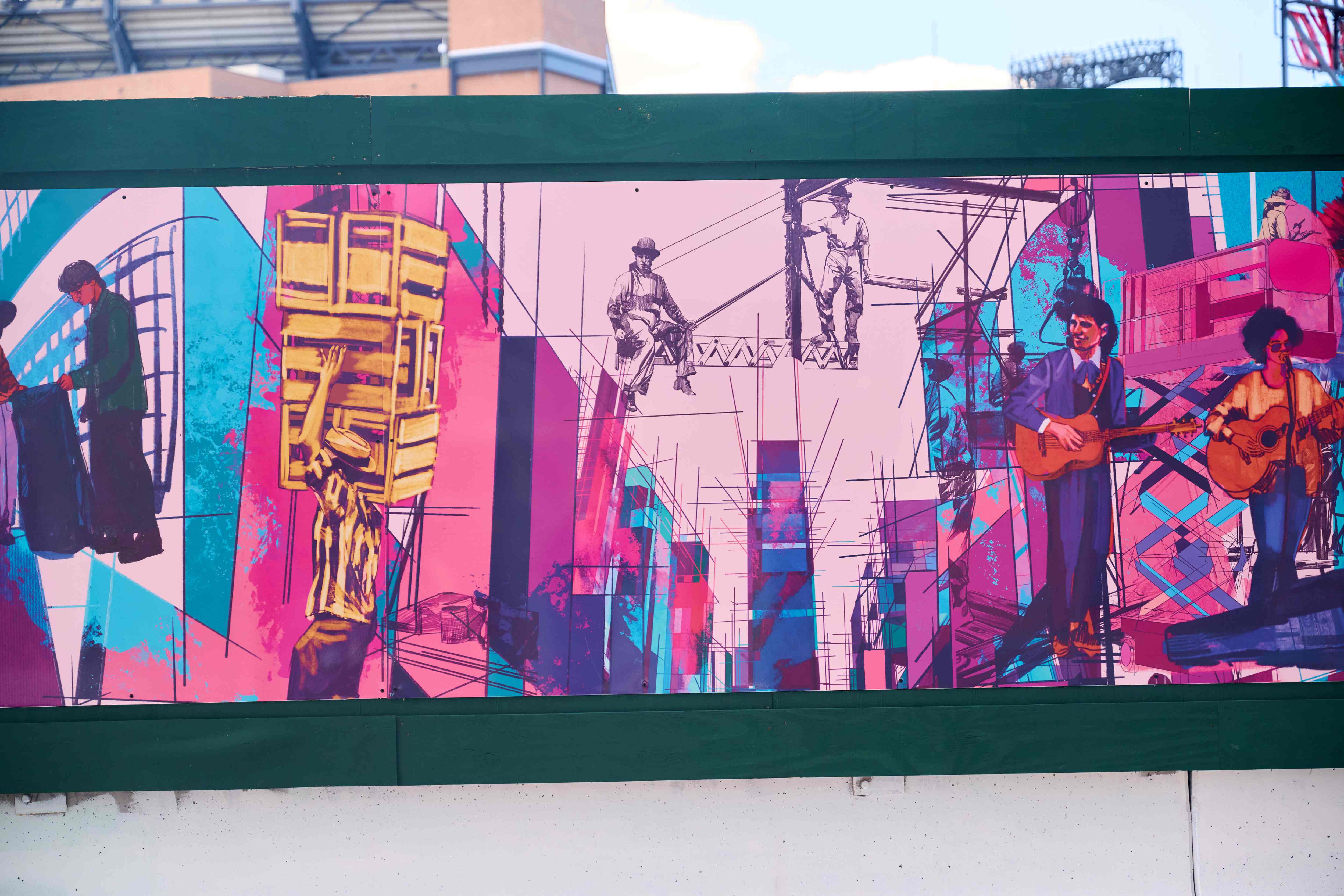 A closeup of the artwork with musicians playing music with colorful buildings.