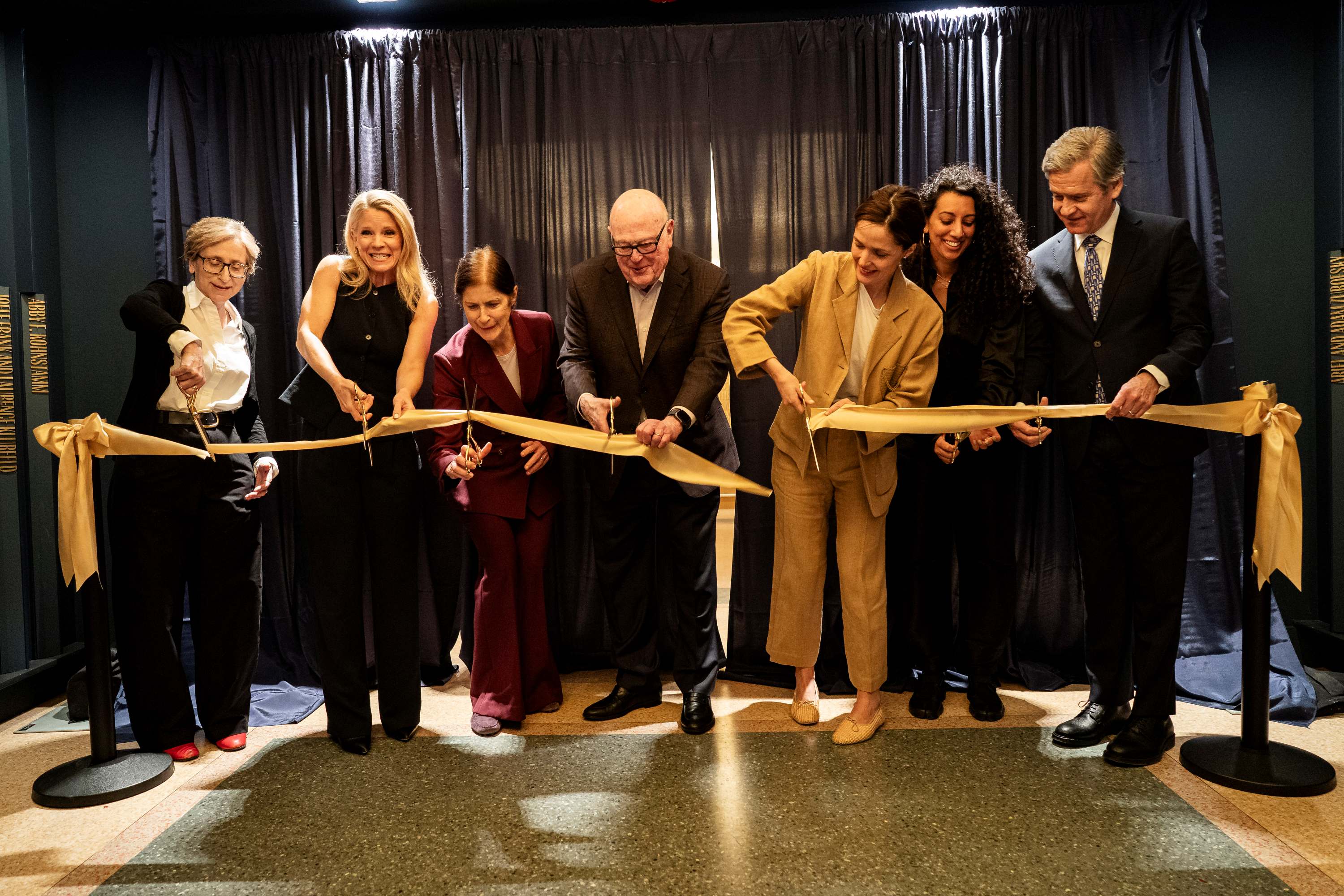 Commissioner Vij joins partners and officials as they cut a celebratory ribbon.