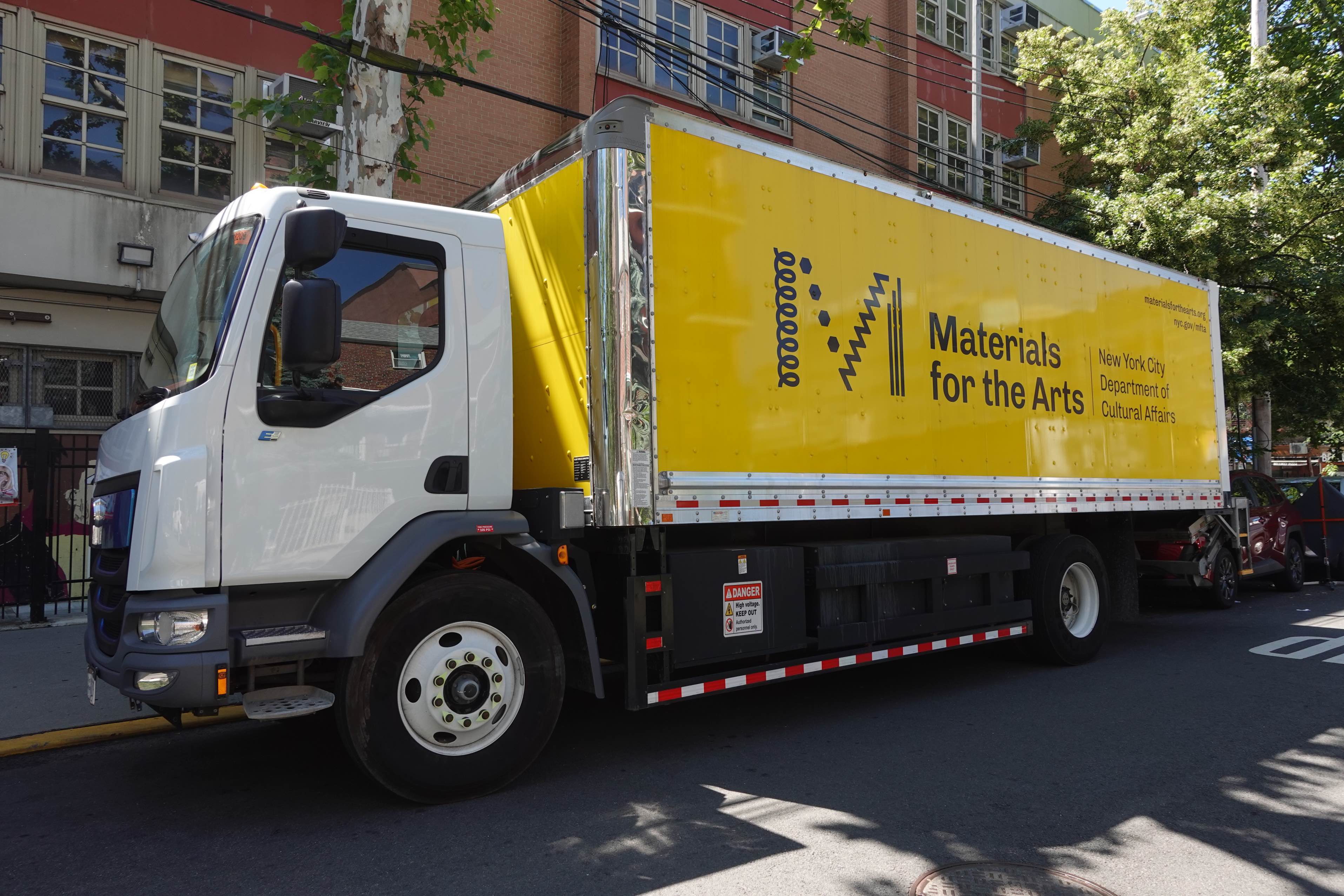 MFTA's big yellow truck with the MFTA logo in front of PS 17.