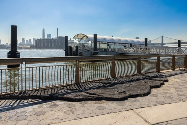 Carlos Irijalba’s wave installation made of asphalt is on the river’s edge. 