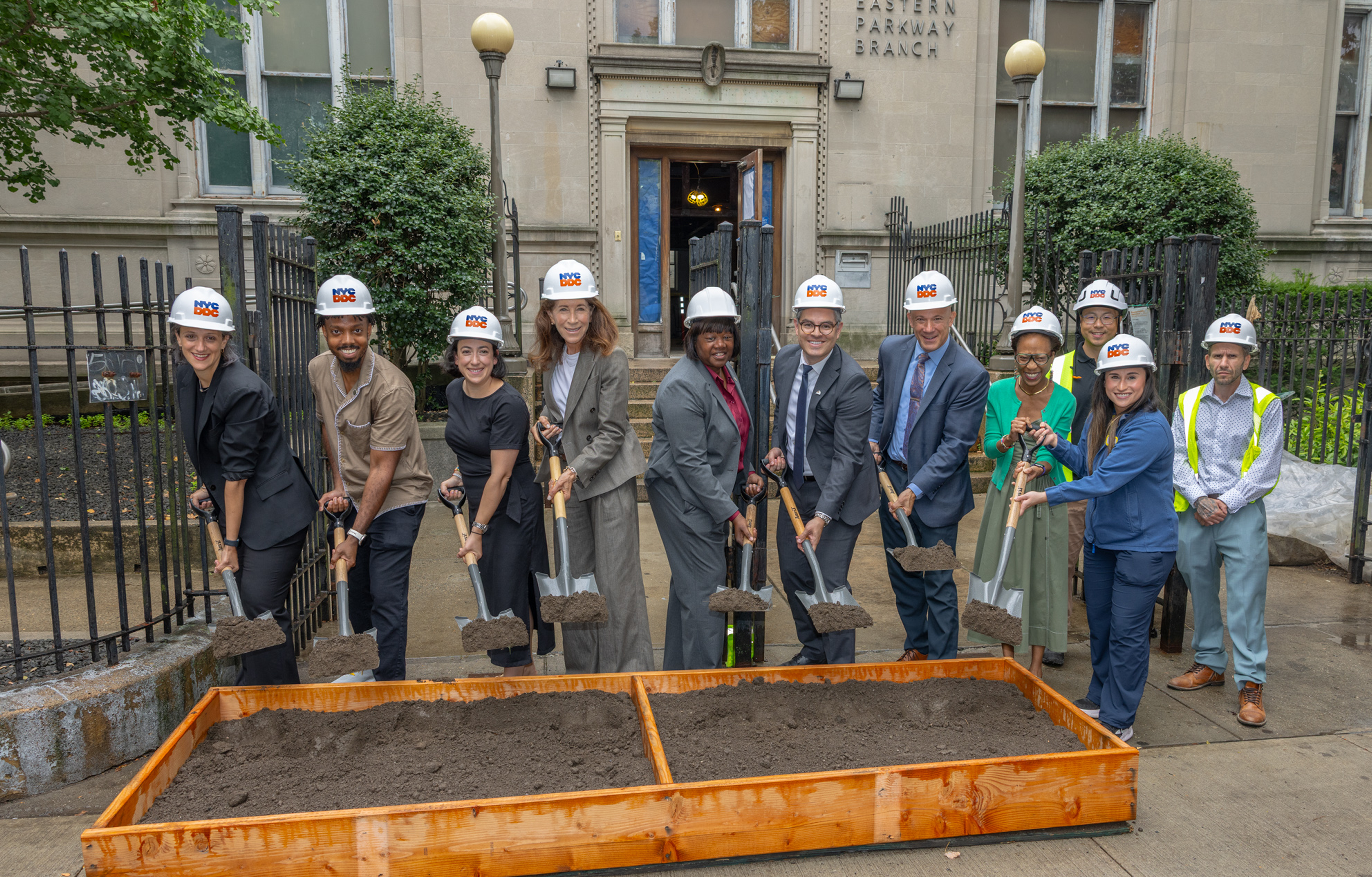 Elected, City officials stand holding shovels to break ground on the new library in Brooklyn
                                           