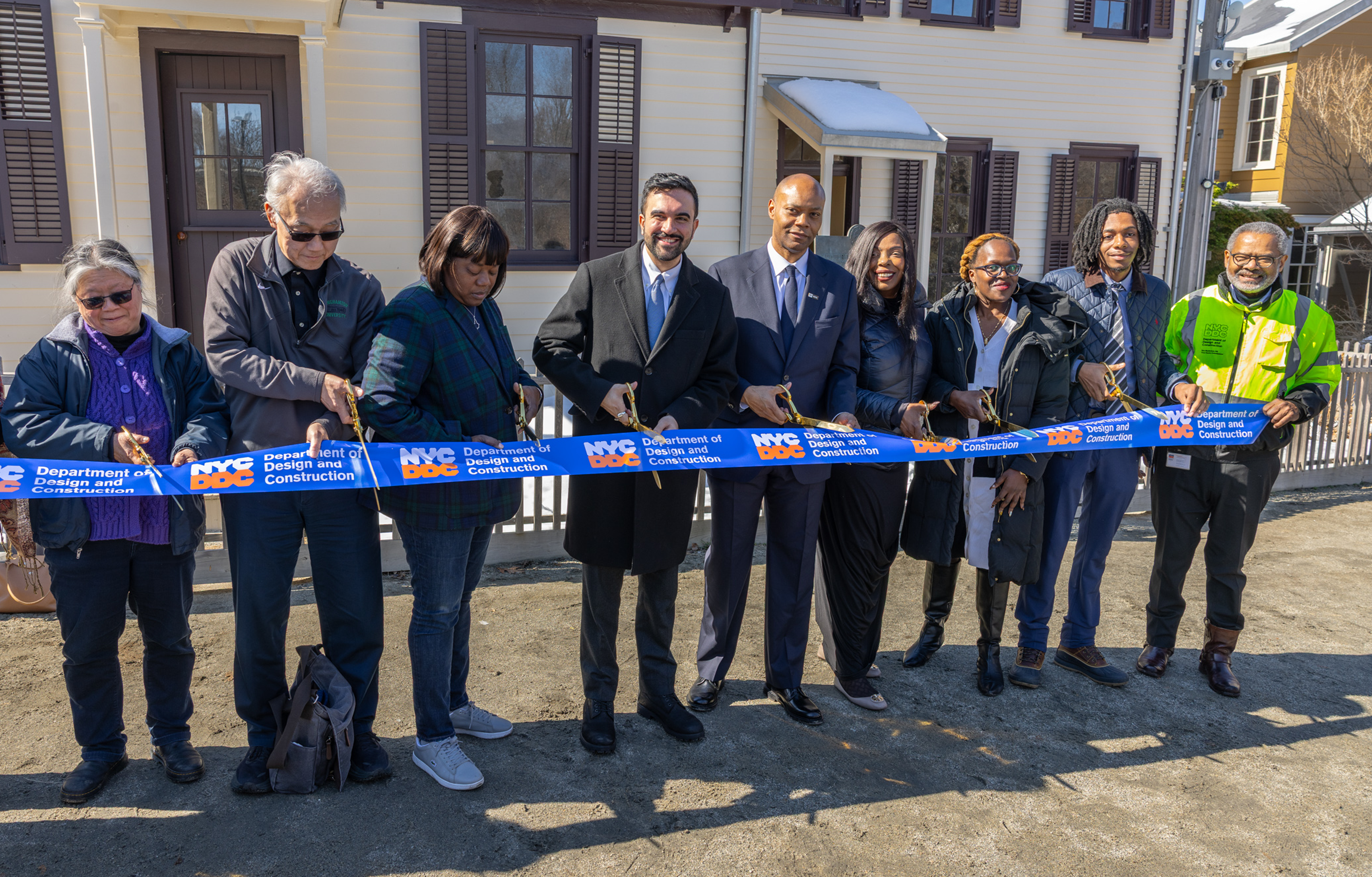 group photo featuring nyc mayor, ddc team members, and others ready to cut the ribbon
                                           