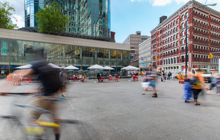 people walking around the newly reconstructed astor place