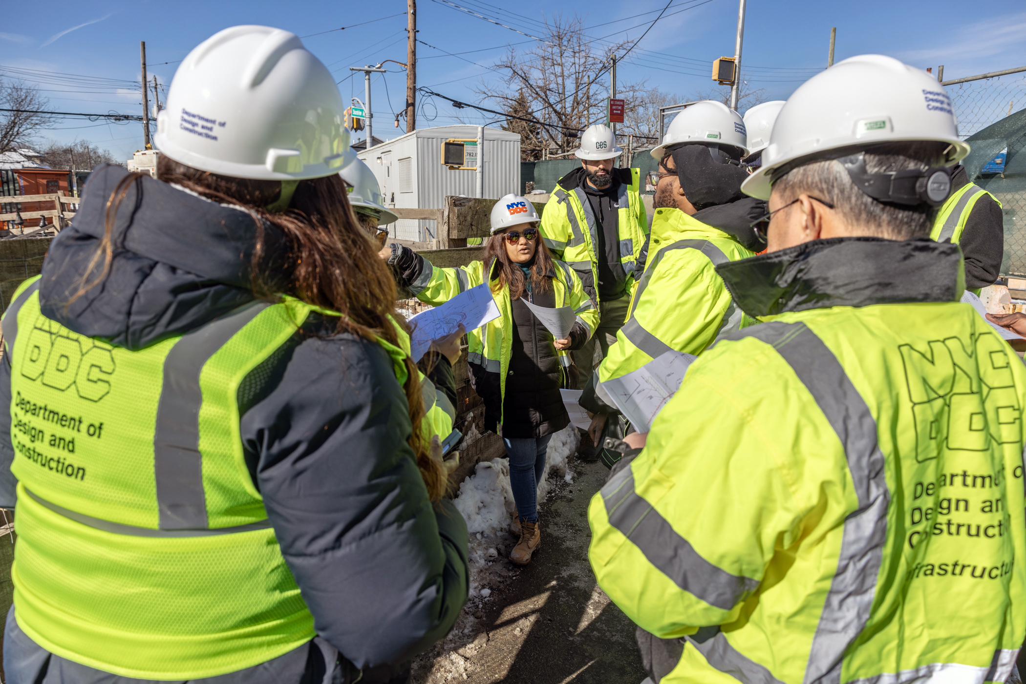 Group photo of DDC employees huddled together to learn about infrastructure project