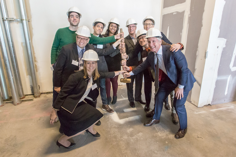 DDC and MCC staff pose with groundbreaking hammer.