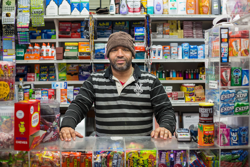 David behind the counter of La Melliza Minimarket