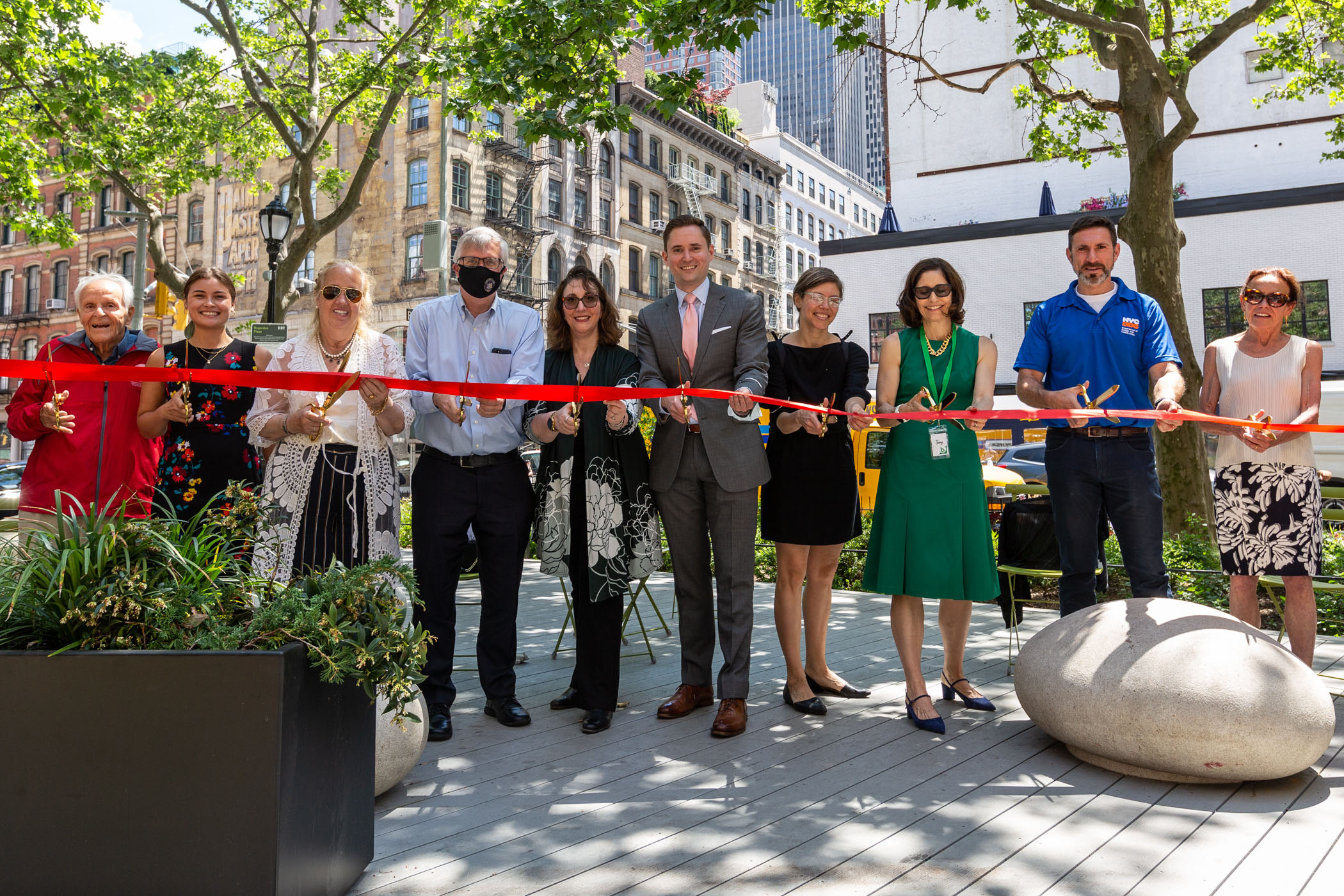 City officials and members of the community join to cut the ribbon at Bogardus Plaza