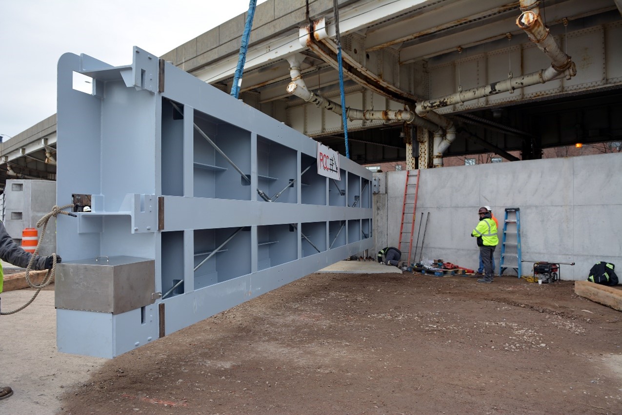 A swinging flood gate at the northern end of Stuyvesant Cove Park being installed in February 2022