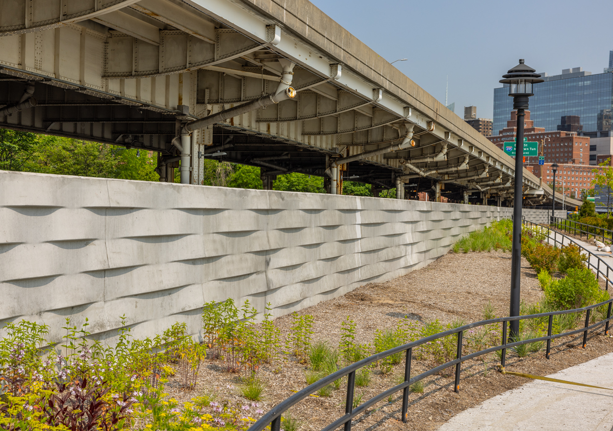 new stuyvesant cove park features plantings and railings next to a floodwall