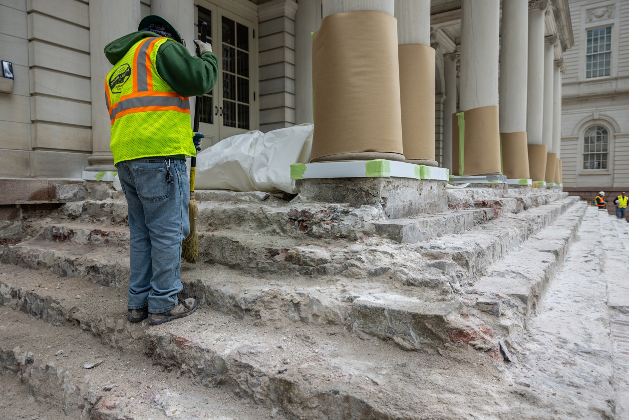 workers work on city hall steps