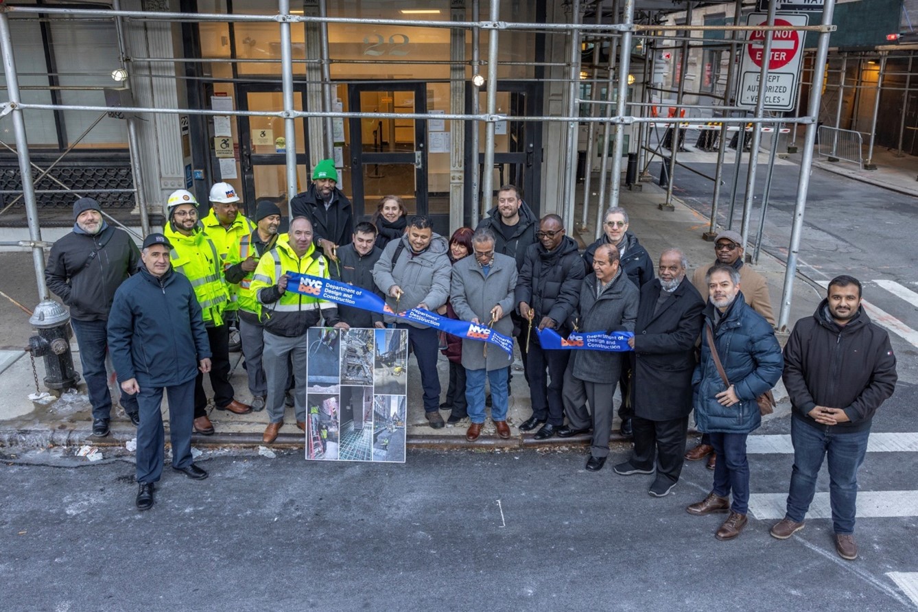 group photo of project team celebrating by holding ribbon