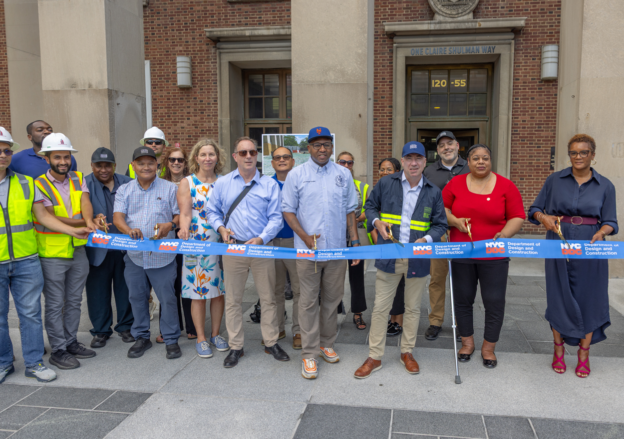 group photo of project team and city officials set to cut the ribbon