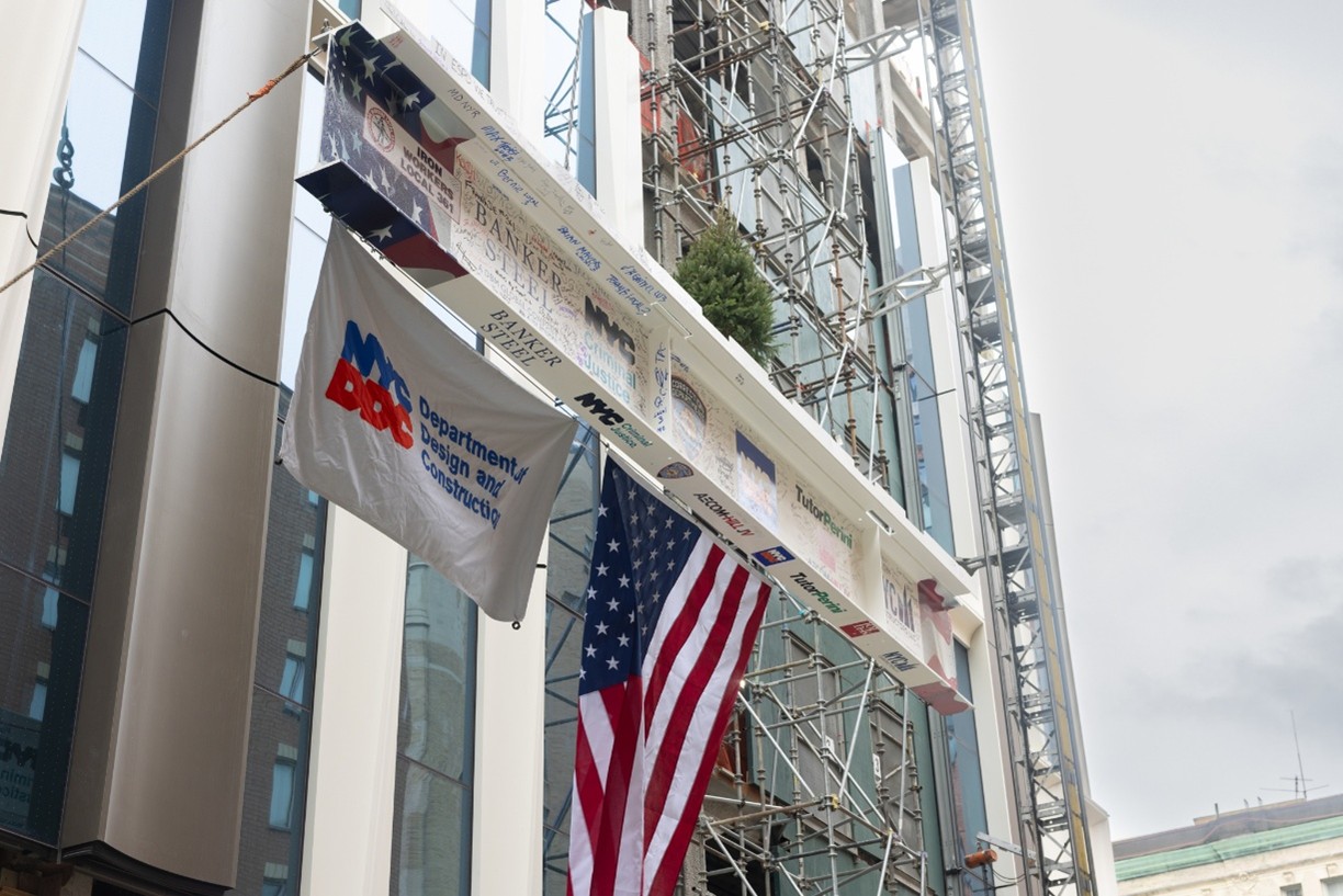 The final steel beam being lifted into place at the Brooklyn jail. 