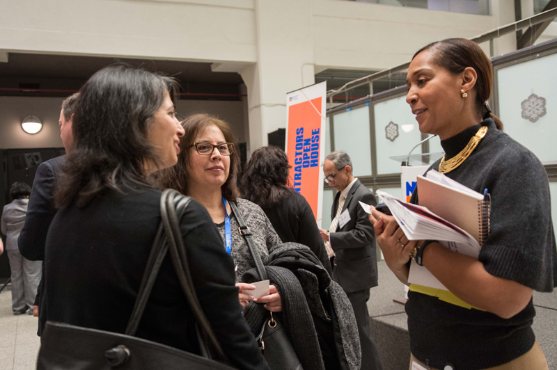 Commissioner Peña-Mora speaks and walks down an aisle.