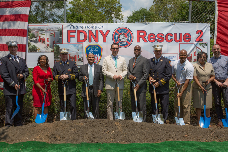 Officials lined up behind shovels for the ground breaking ceremony.