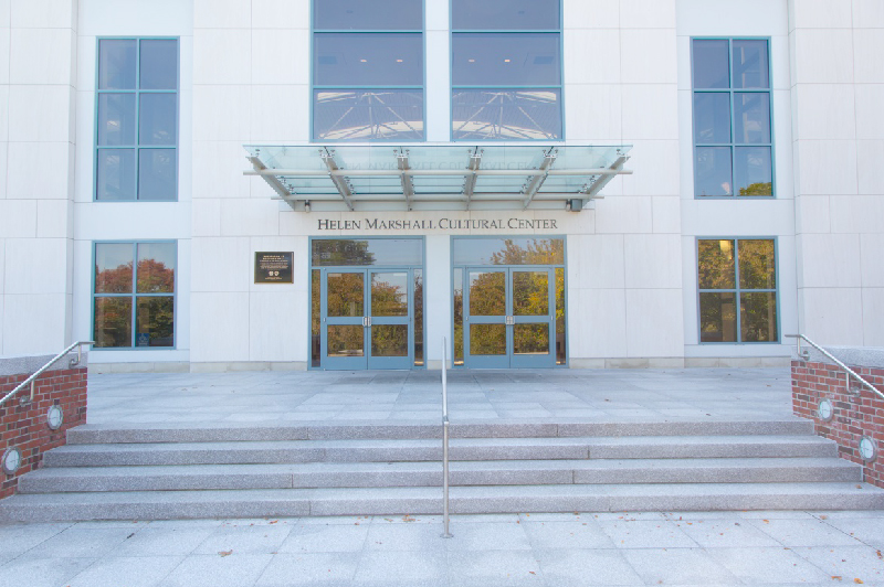 A new, bright facade of a building. Above the double doors, a wall-mounted sign says Helen Marshall Cultural Center.