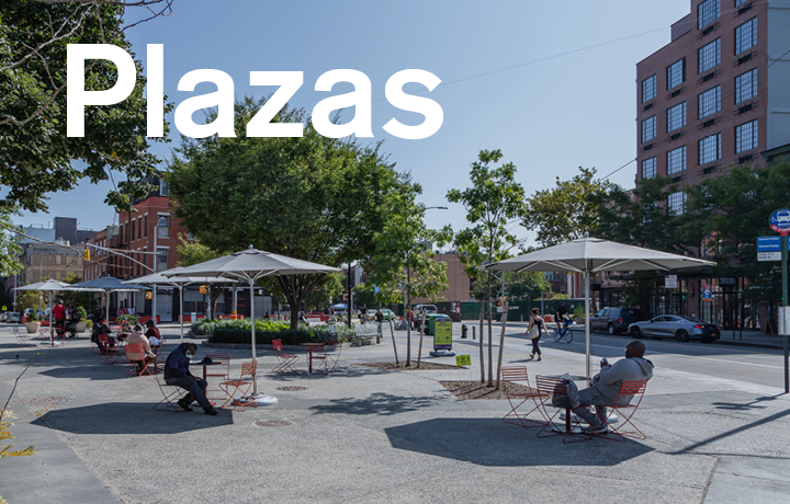 public plaza with a person sitting at a table