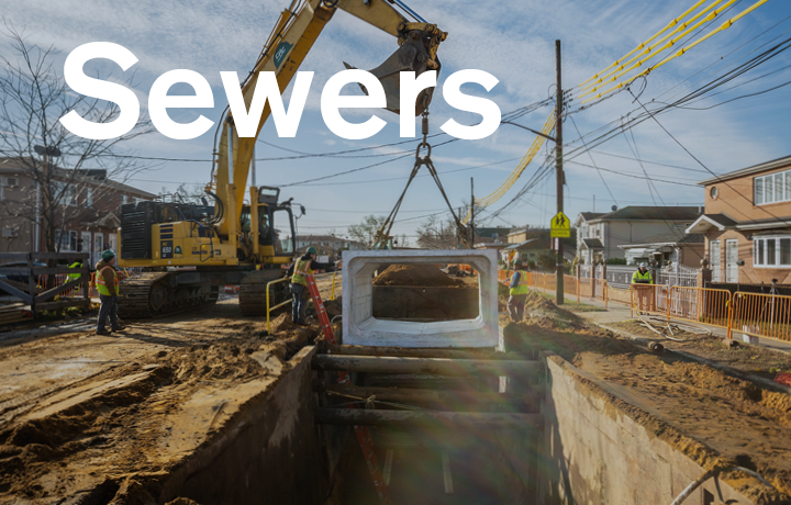 a crane lifting a part of a sewer