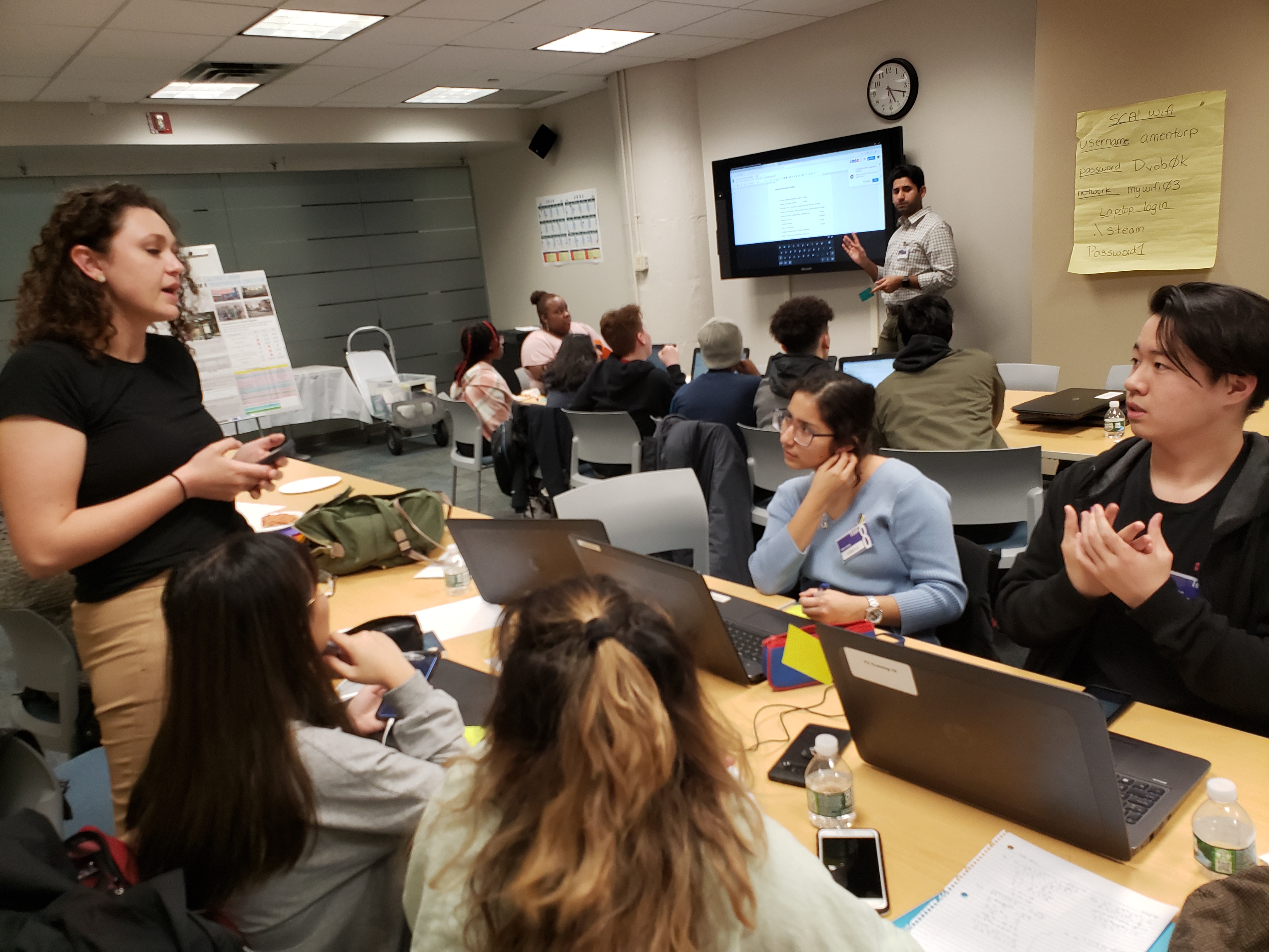 Students sit around the table for a group discussion.