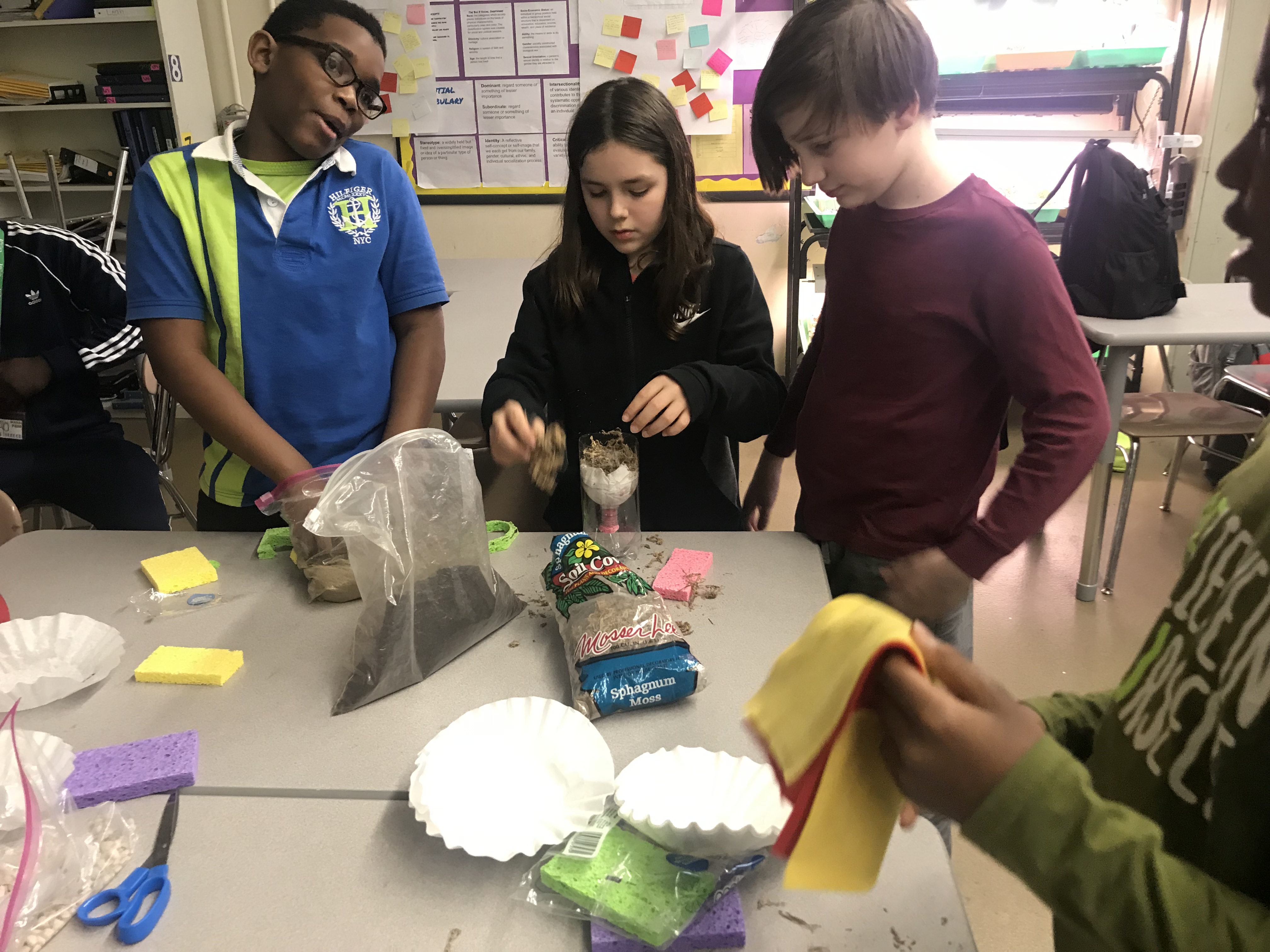 three students work on STEAM presentations