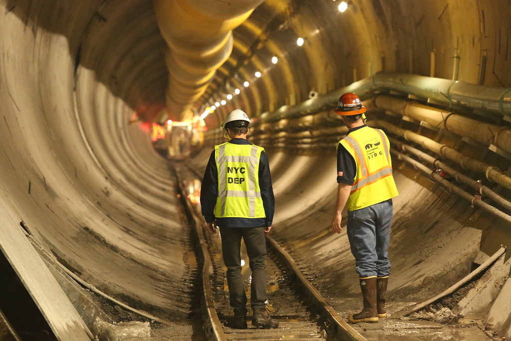 Two DEP workers walk through bypass tunnel during construction