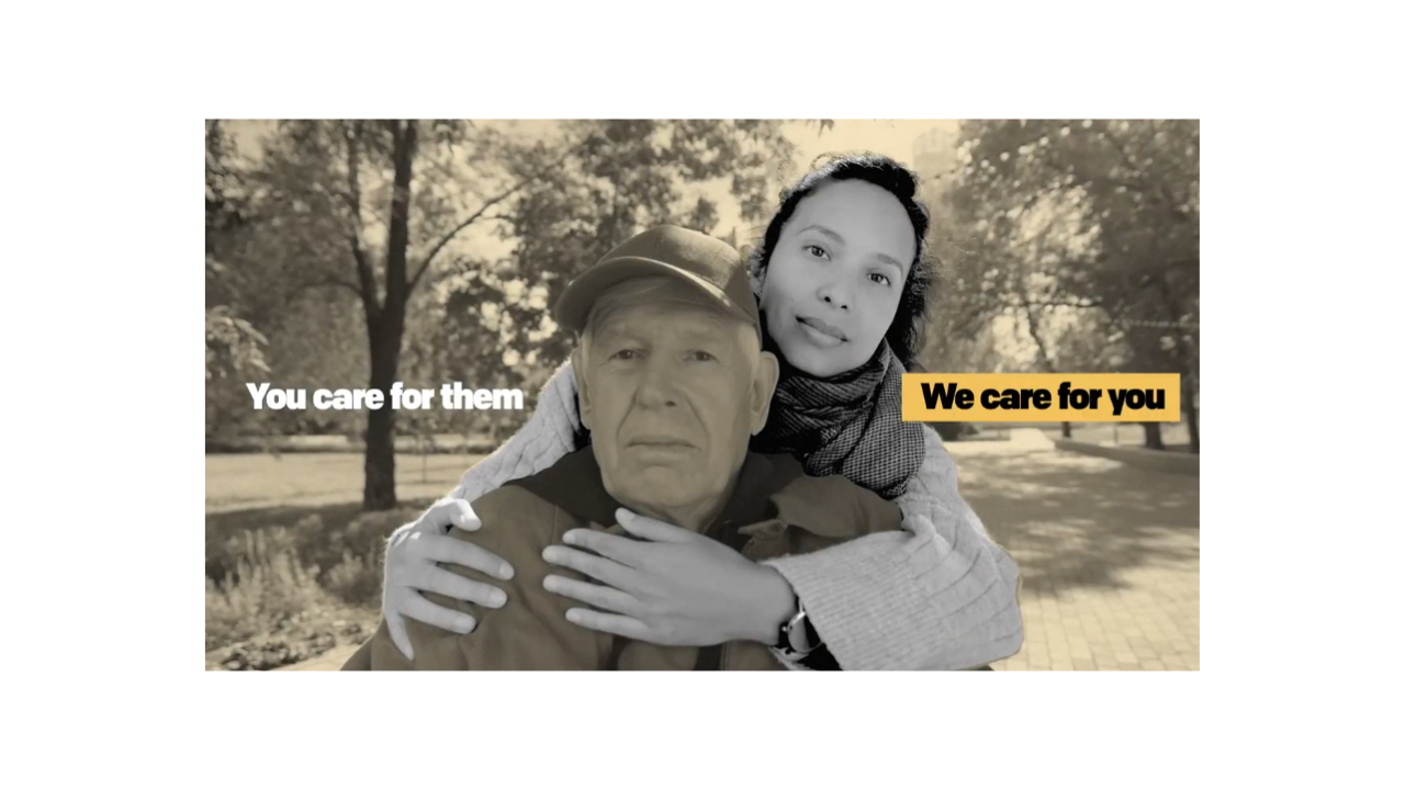 A caregiver embraces an older man from behind in a park as text reads, &ldquo;You care for them. We care for you,&rdquo; highlighting support for caregivers.