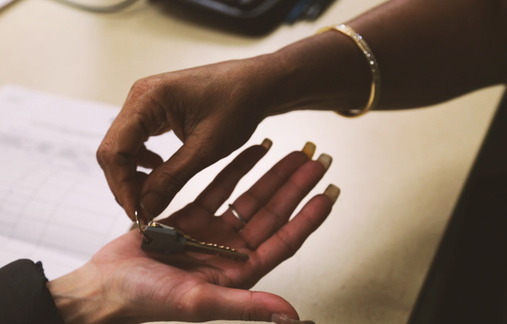 Closeup of person receiving a pair of keys