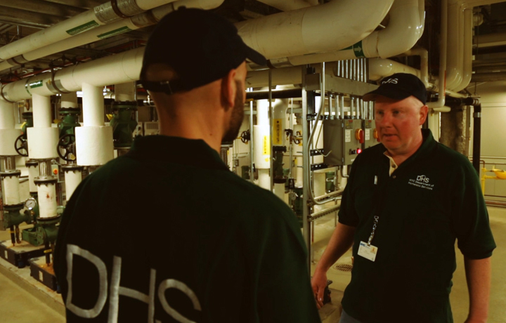 Two DHS employee repairmen talking