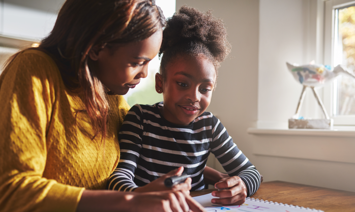 Mother helping her daughter with homework