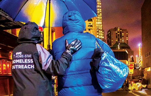 A NYC Homeless Outreach personal helping someone out 