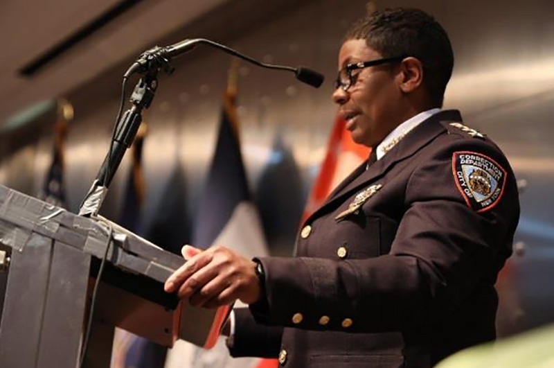 An DOC officer speaking at a podium