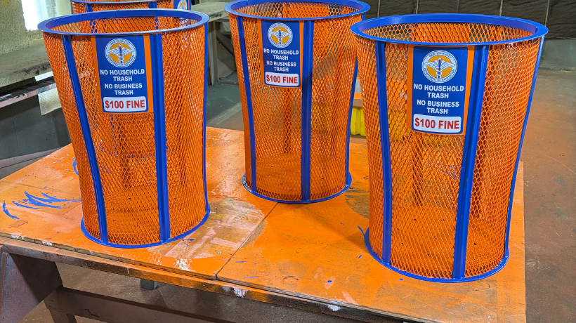 DSNY traditional metal mesh litter baskets painted in bright orange and blue
                                           