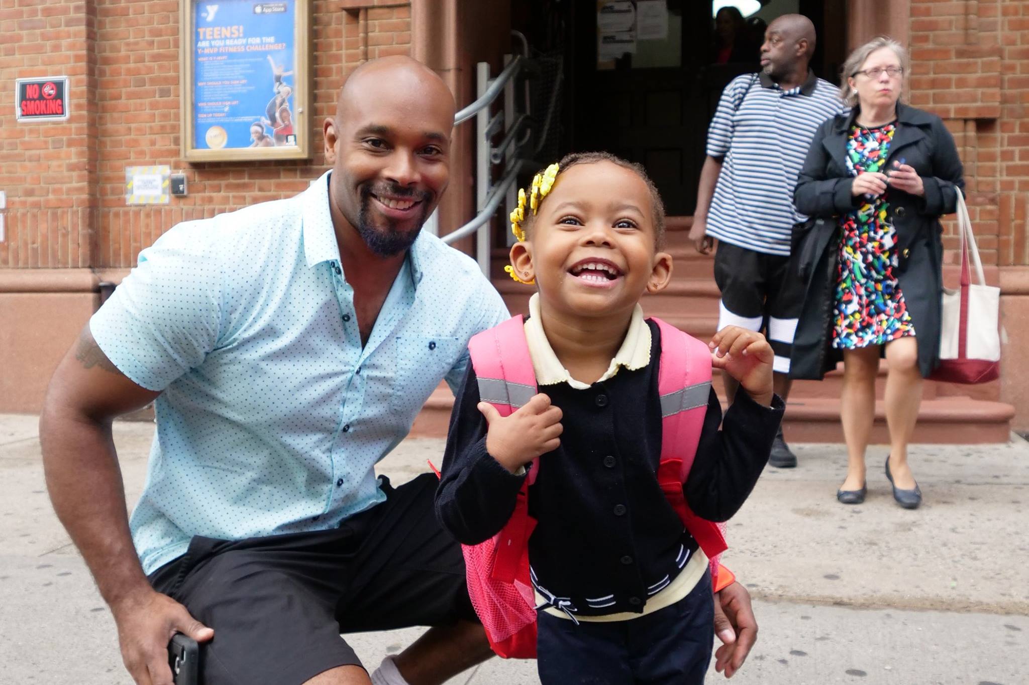 Father & daughter smile as they pose for picture