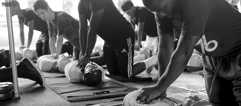 group of men practicing during a CPR training class