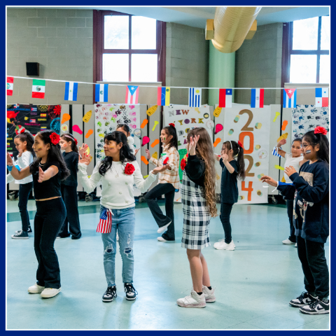 children dancing in a school classroom.